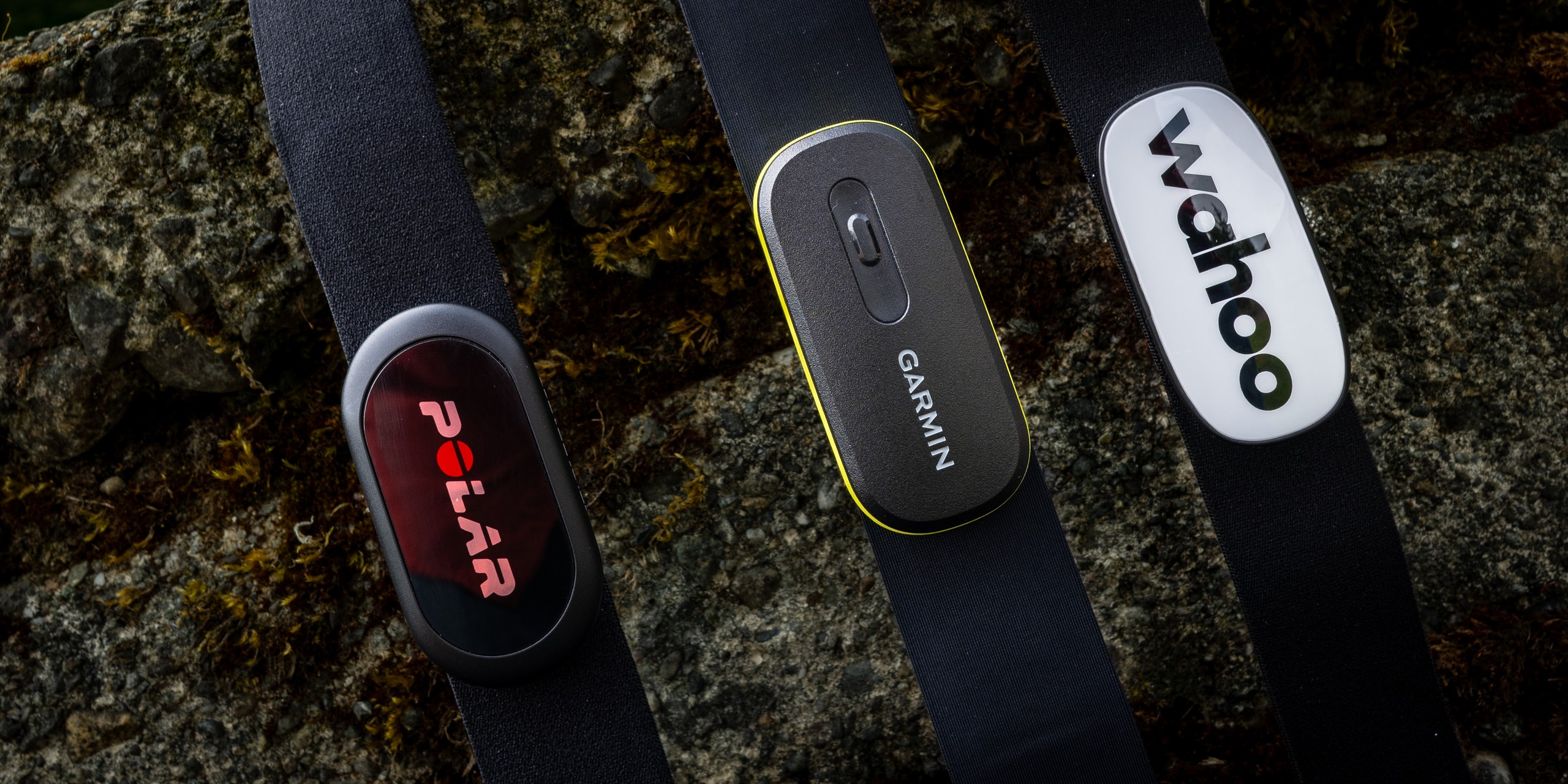 Heart rate chest strap next to a fitness watch