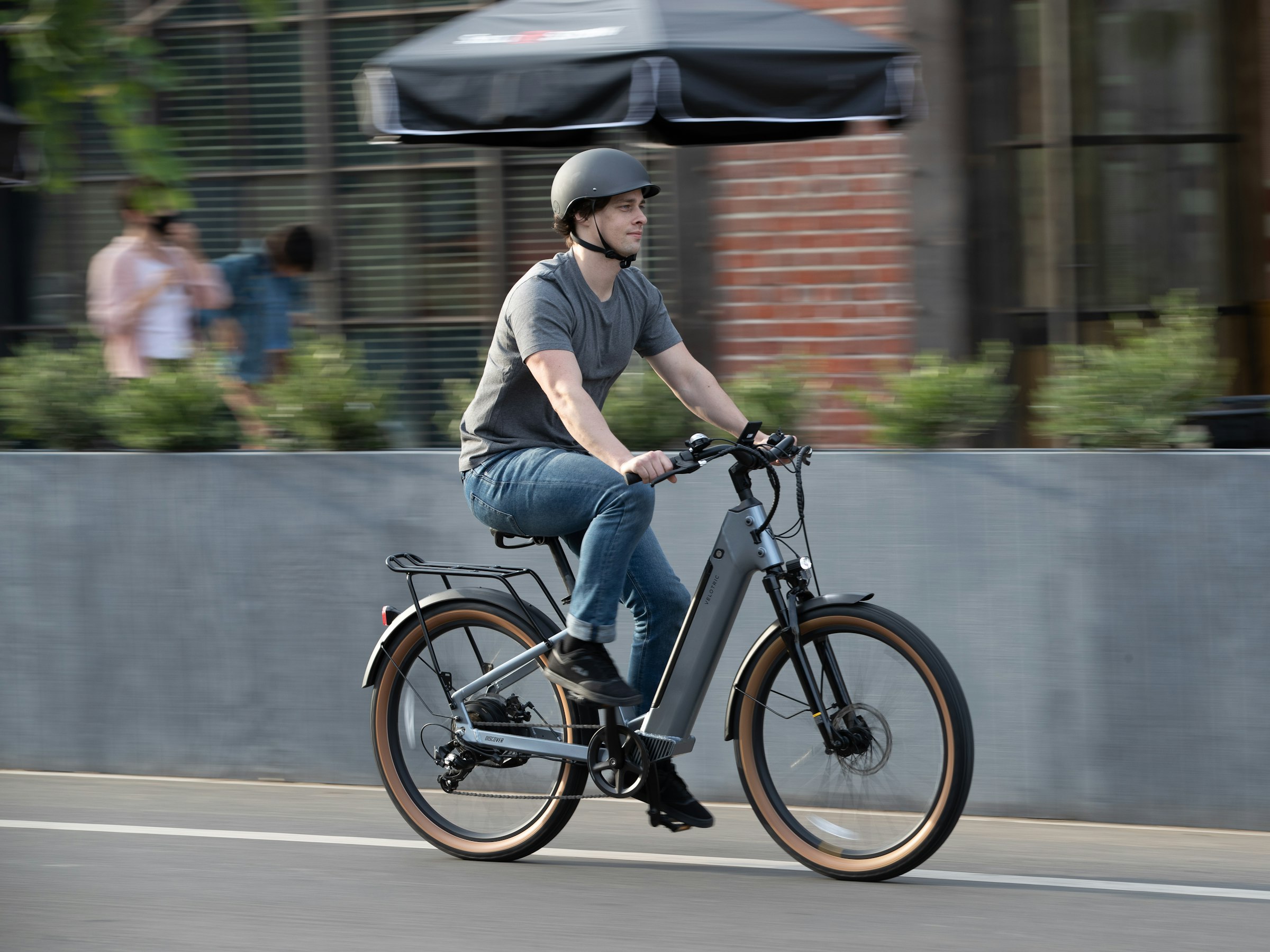 Man riding a mid-drive electric bike on an urban street