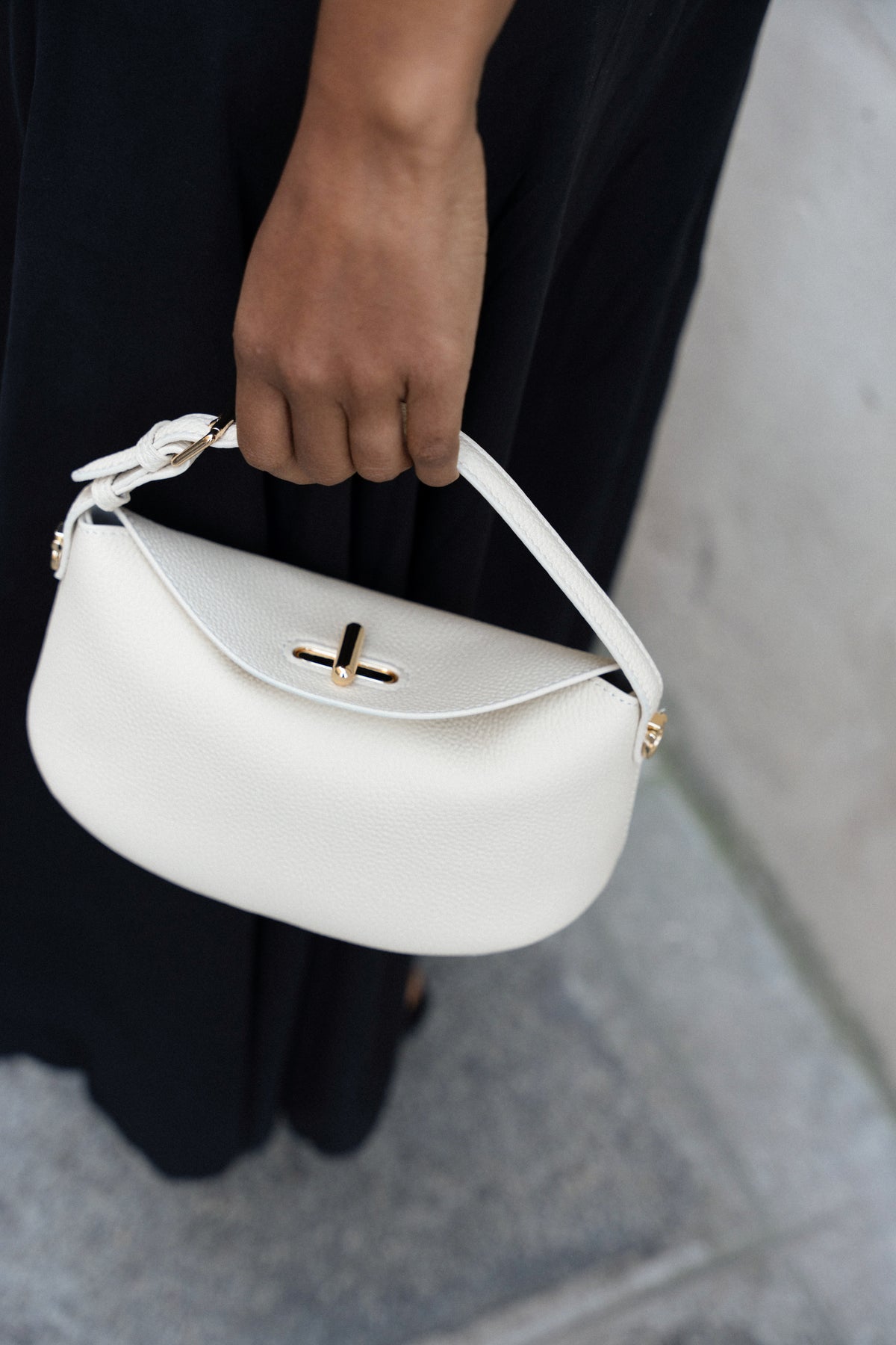 White Lune shoulder bag from Bob Oré's Blue Collection being held by hand