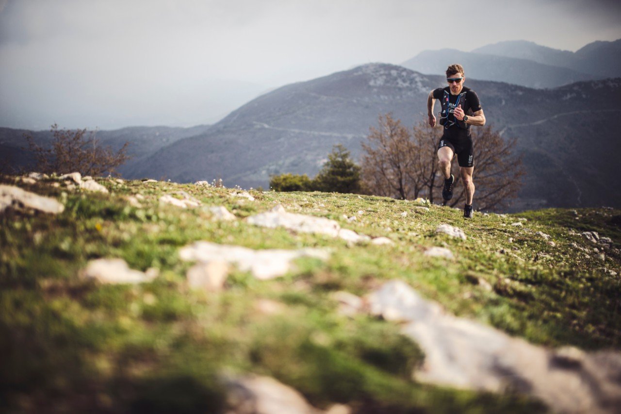 Athlete running outdoors wearing a fitness tracker