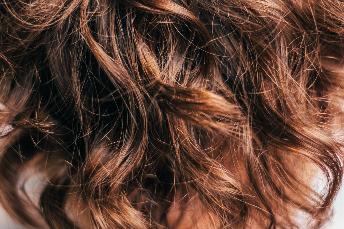 Close-up of wavy brown hair seen from above