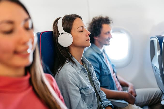 Headphones worn on an airplane