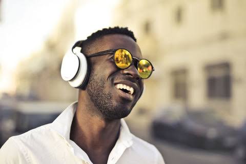 Person wearing glasses and over-ear headphones together