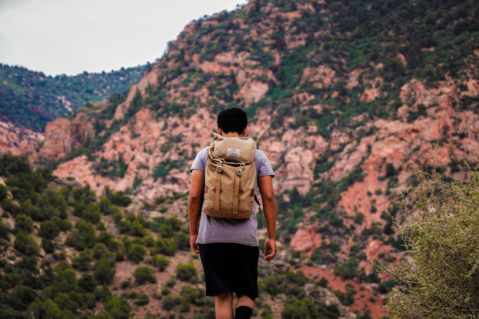 A hiker wearing a backpack on a mountain trail