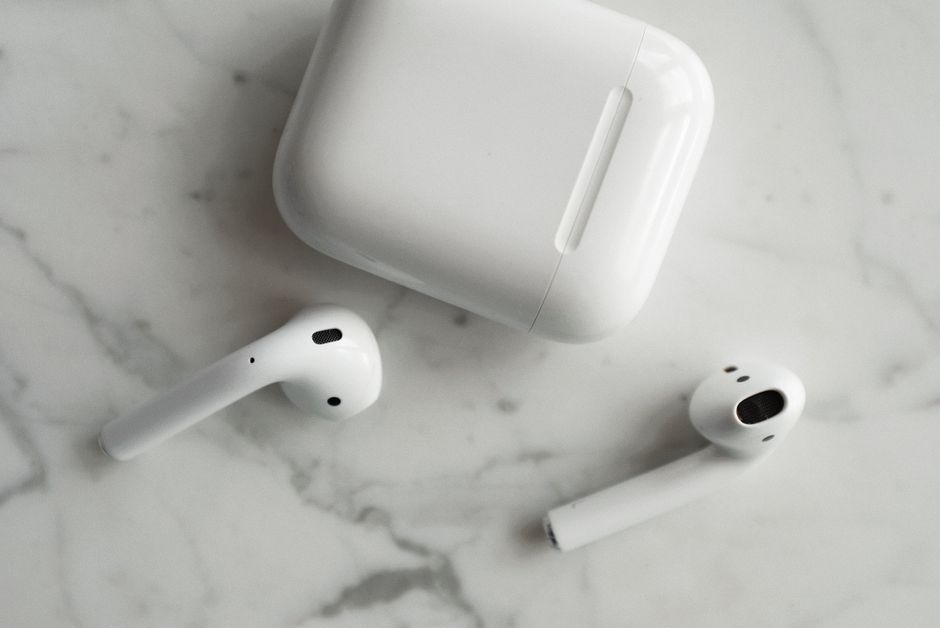 Wireless earbuds resting in an open charging case